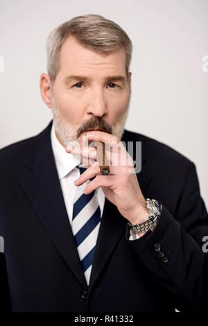 Businessman smoking cigar Stock Photo