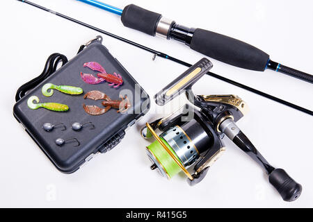 Fishing rod and reel with box for baits on white. Stock Photo