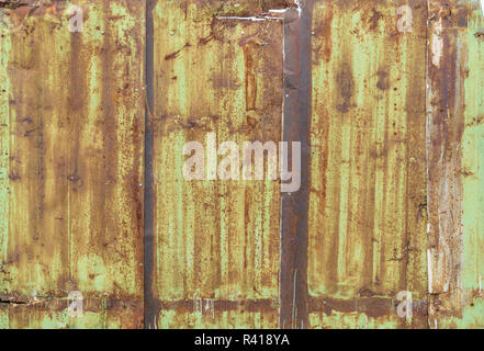 Fragment of a fence from a rusty metal sheets Stock Photo