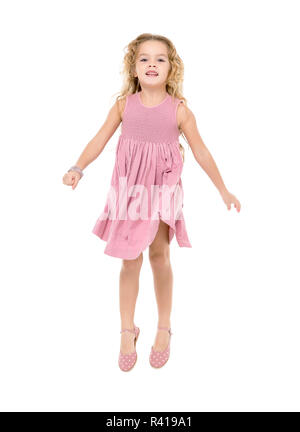 Little Girl in a Pink Dress Jumping Stock Photo