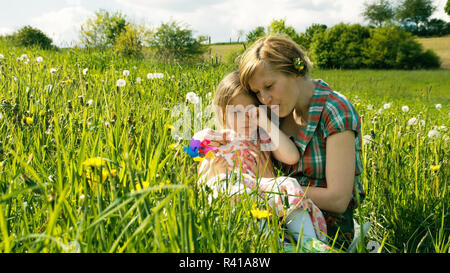 the mother consoles her daughter on a spring meadow - part 2 Stock Photo