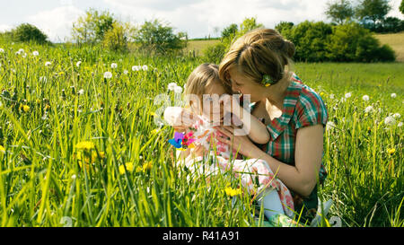 the mother consoles her daughter on a spring meadow - part 4 Stock Photo