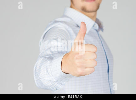 Young businessman shows thumbs up Stock Photo