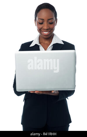 Female executive working on laptop Stock Photo