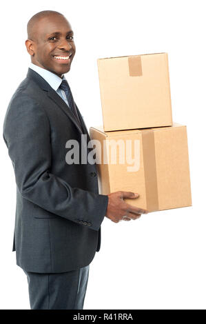 Businessman holding packed cartons Stock Photo