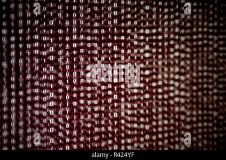 red binary code background. dangerous virus infection internet connection. computer errors and hacker breaching into the computer system. soft focus a Stock Photo