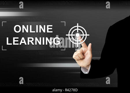 business hand pushing online learning button on touch screen Stock Photo