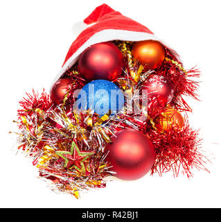 xmas decorations pour out from red santa hat Stock Photo