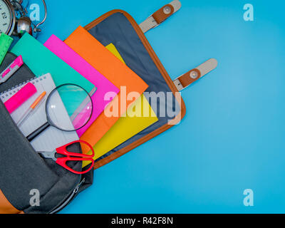 Back to school concept. Backpack with school supplies. Top view. on blue background Stock Photo