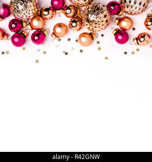 Christmas white minimalistic background. Shining gold and pink balls and confetti border. Stock Photo