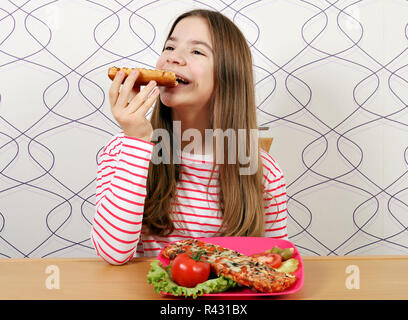 hungry teenage girl eats sandwich Stock Photo