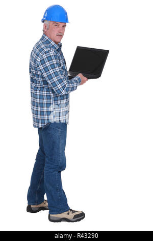 Senior worker holding laptop Stock Photo