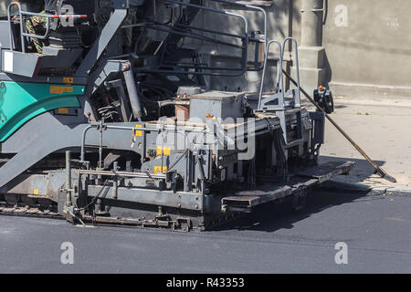 machine for laying asphalt closeup on the street Stock Photo