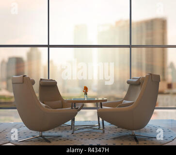 Lobby area of a hotel which can see abstract Blurred photo of cityscape with sun background Stock Photo