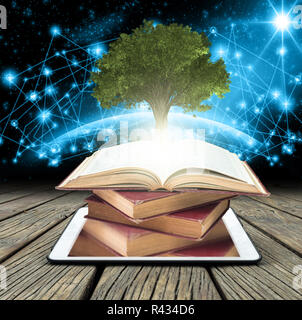 Tree growing from the old books over tablet on Part of earth with network line and point on the star and dark background, Education and knowledge with Stock Photo