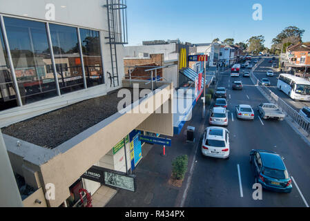 Shops of varying height and age line the Pacific Highway at Gordon on Sydney Australia's north shore as traffic streams past on a Saturday morning. Stock Photo