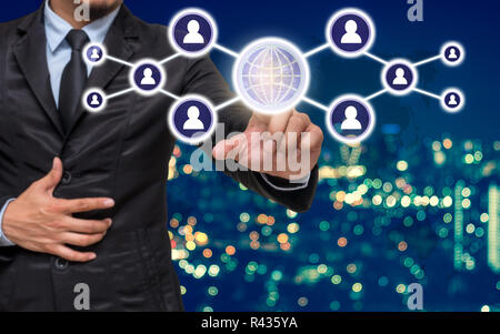 Businessman pointing or touching the Social media symbol on Blurred Photo bokeh of cityscape, Elements of this image furnished by NASA, Business netwo Stock Photo