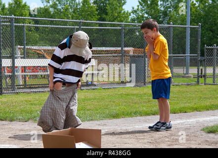 Middletown, CT USA. Jun 2009. Running boys playing clothes change relay at school. Stock Photo