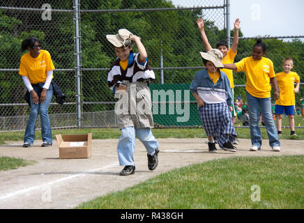 Middletown, CT USA. Jun 2009. Running boys playing clothes change relay at school. Stock Photo