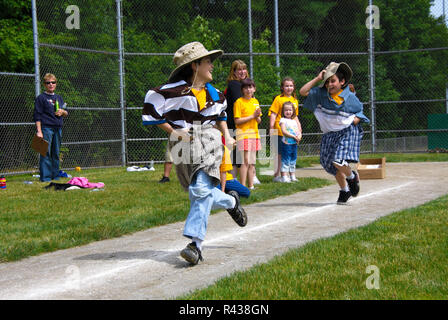 Middletown, CT USA. Jun 2009. Running boys playing clothes change relay at school. Stock Photo