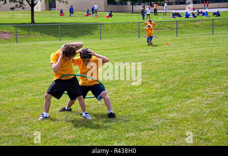 Middletown, CT USA. Jun 2009. Walking boys playing Hula Hoop race or relay at school. Stock Photo