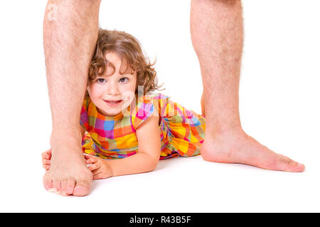 Little daughter at the feet of her father Stock Photo