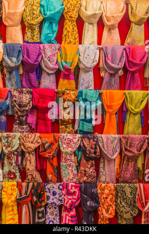Colorful scarfs on display on racks in a bazaar. Stock Photo