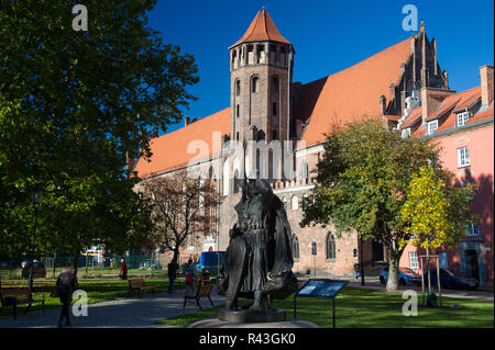 Statue of Swietopelk II, duke of Pomerania, and Dominican Gothic church of St Nicholas in Main City in historic centre of Gdansk, Poland. October 31st Stock Photo