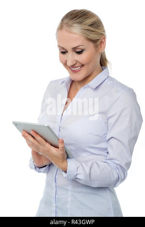 Smiling female executive working on tablet Stock Photo