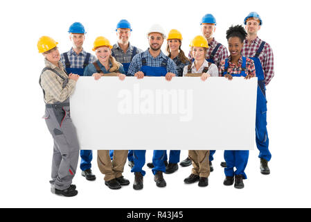 Happy Construction Workers Holding Blank Billboard Stock Photo