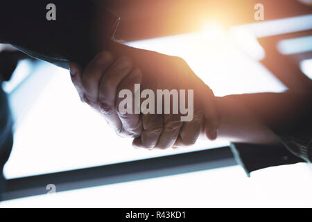 Handshaking business person in the office with network effect. concept of teamwork and partnership Stock Photo