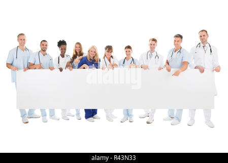Confident Multiethnic Medical Team Holding Blank Billboard Stock Photo