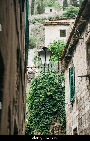 Street lights on the outside of a stone apartment building. Stock Photo
