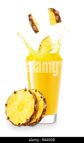 pineapple pieces falling into glass with juice and creating splashes isolated on white background Stock Photo