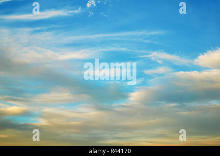 Wavy, curly, porous clouds against a blue sky. Nature Background Stock Photo
