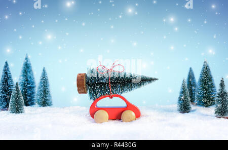 Incoming Cristmas Concept - Car Carrying A Christmas Tree In Snowy Landscape Stock Photo