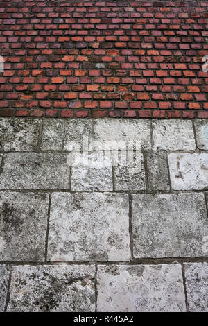 Old wall background with large stone blocks and bricks of Wawel Castle in Krakow, Poland Stock Photo