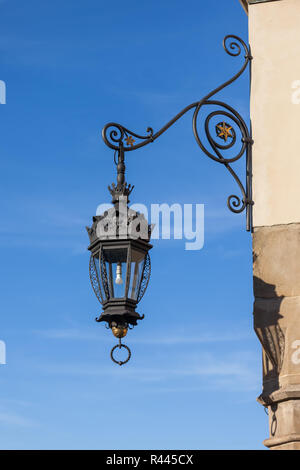 Vintage ornamental lamp on Cloth Hall (Sukiennice) in Krakow, Poland. Stock Photo