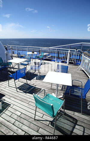 Chairs and tables on a ferry deck Stock Photo