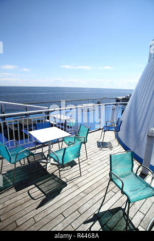 Chairs and tables on a ferry deck Stock Photo