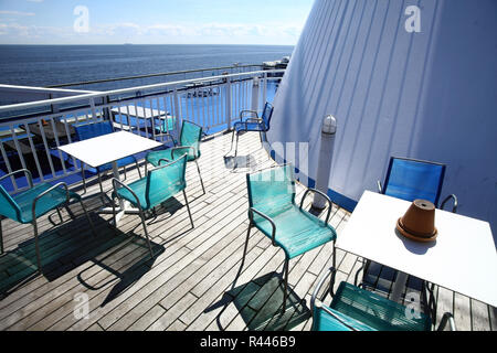 Chairs and tables on a ferry deck Stock Photo