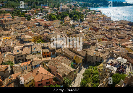 View over Lake Garda over the tiled roofs of Malcesine, Lake Garda, Italy, Veneto region of Italy. Aerial view, top view Stock Photo
