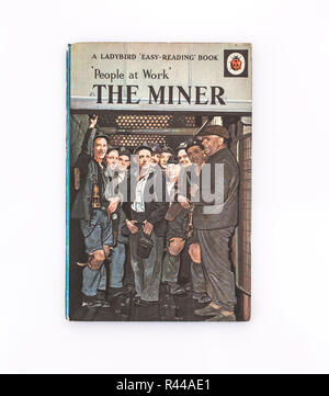 SWINDON, UK - NOVEMBER 18, 2018:  The Miner Ladybird book from the People at work series,  A LADYBIRD Easy-Reading Book on a white background Stock Photo
