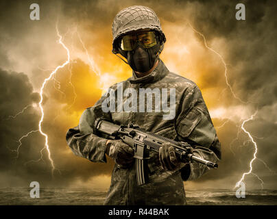 Armed soldier standing in rainy obscure weather  Stock Photo