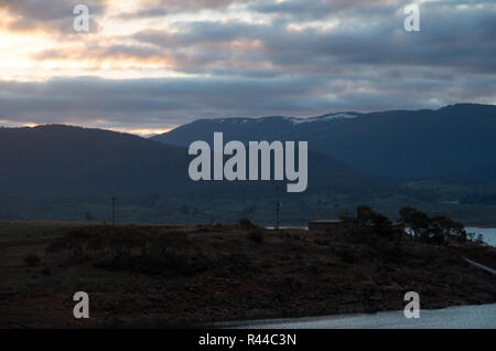 Sunset over Lake Jindabyne & snowy Mountains on a cloudy afternoon Stock Photo