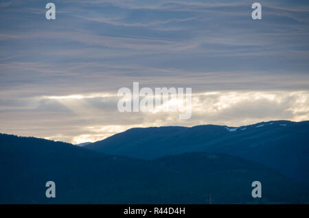 Soft Fluffy clouds near sunset over Lake Jindabyne and the mountains Stock Photo