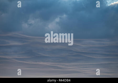 Soft Fluffy clouds near sunset over Lake Jindabyne and the mountains Stock Photo