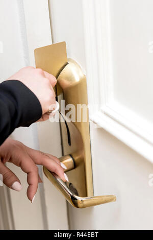 Woman opening door lock with an electronic card Stock Photo