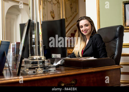 Female receptionist working on computer Stock Photo