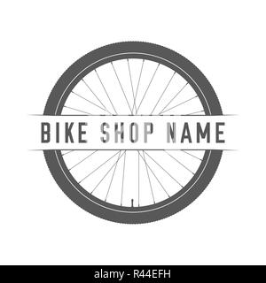 Bikes Shop Emblem. Design Element for Bike Shop or Advertising Banner. Bicycle Wheel Silhouette and Place for Your Bike Shop Name, Monochrome Illustra Stock Photo